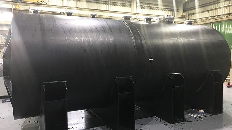 Finished tank including connection flanges and manhole