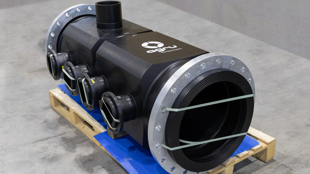 Large pipe header with several side outlets and flanges, secured on pallet